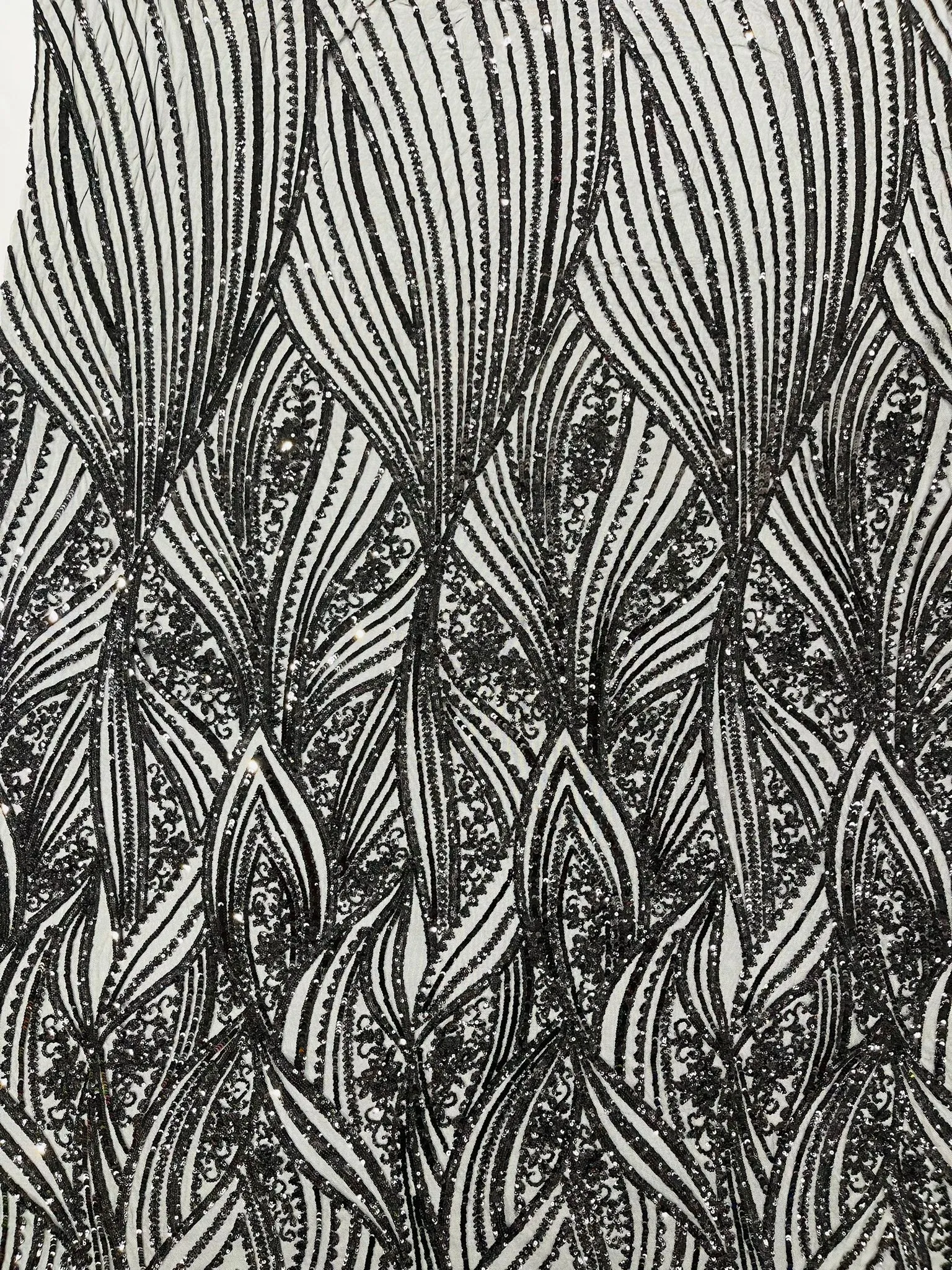 Geometric Feather wing shiny sequin design on a 4 way stretch mesh Fabric-old by the yard.