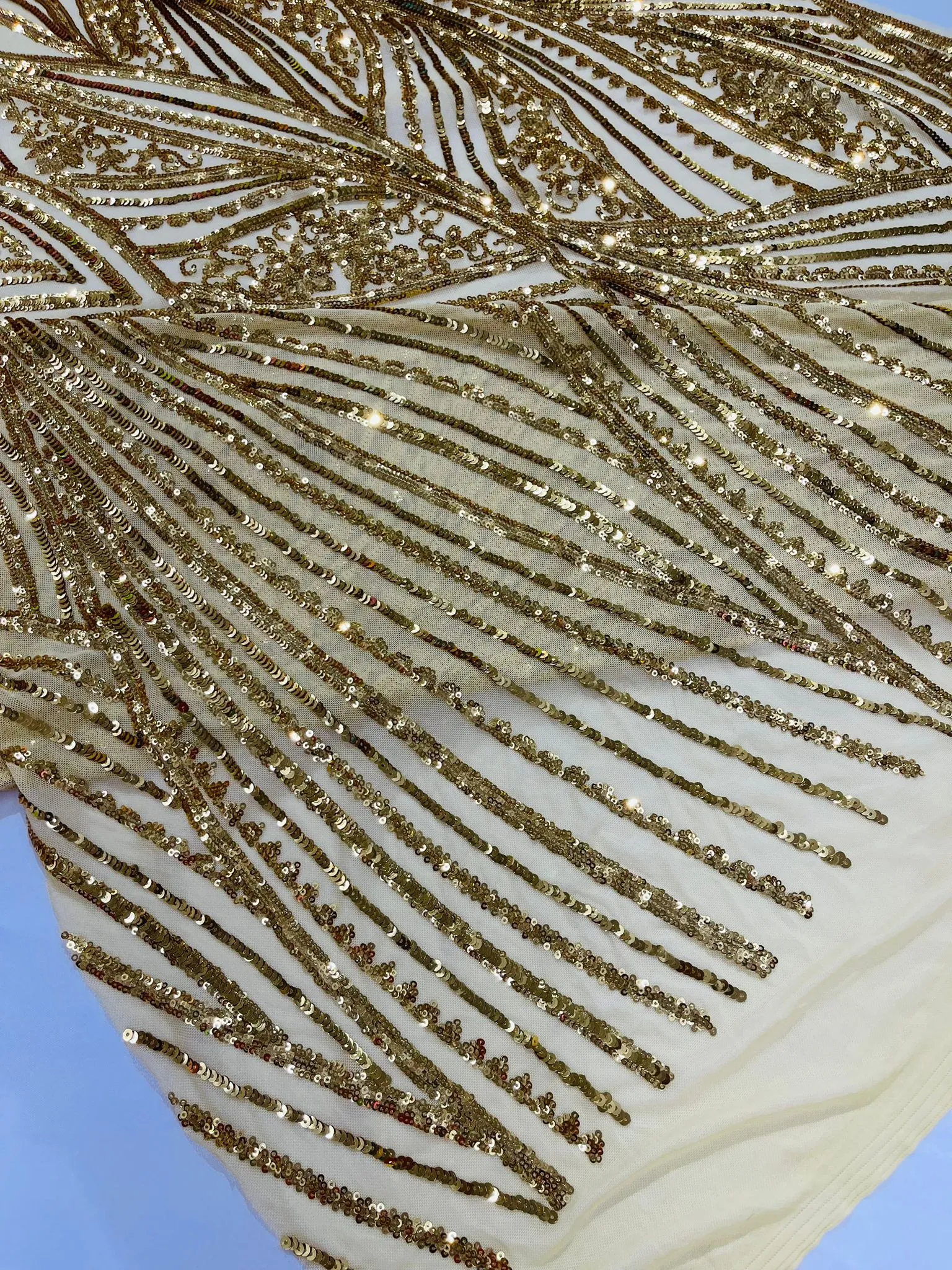 Geometric Feather wing shiny sequin design on a 4 way stretch mesh Fabric-old by the yard.