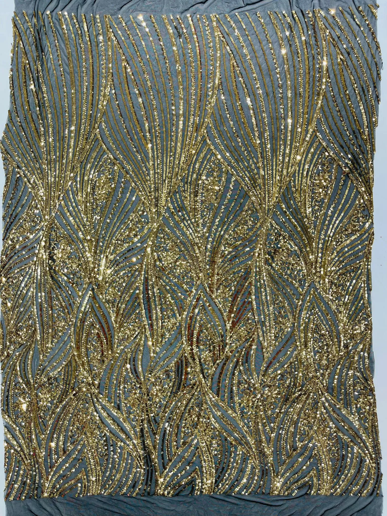 Geometric Feather wing shiny sequin design on a 4 way stretch mesh Fabric-old by the yard.