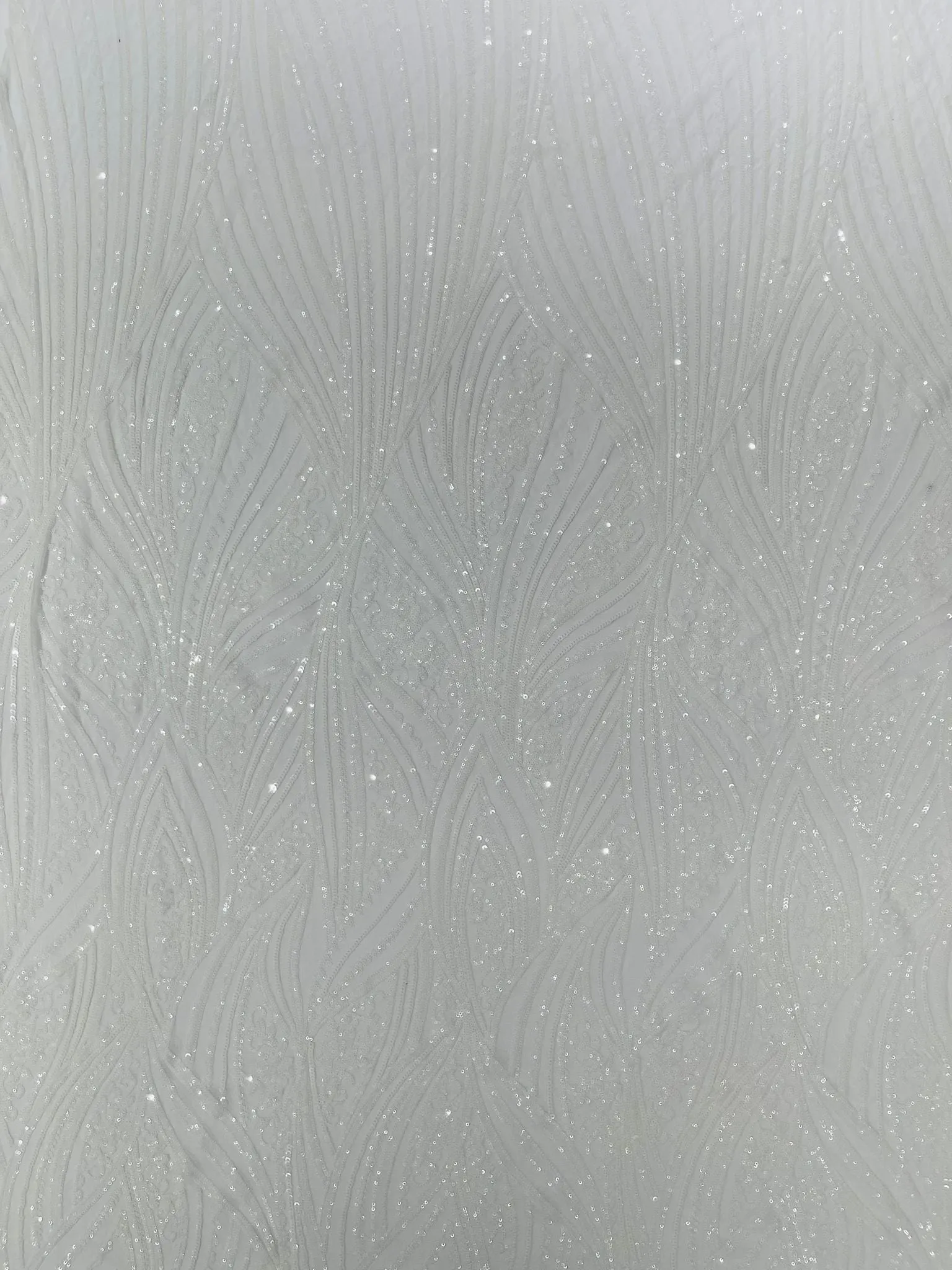 Geometric Feather wing shiny sequin design on a 4 way stretch mesh Fabric-old by the yard.