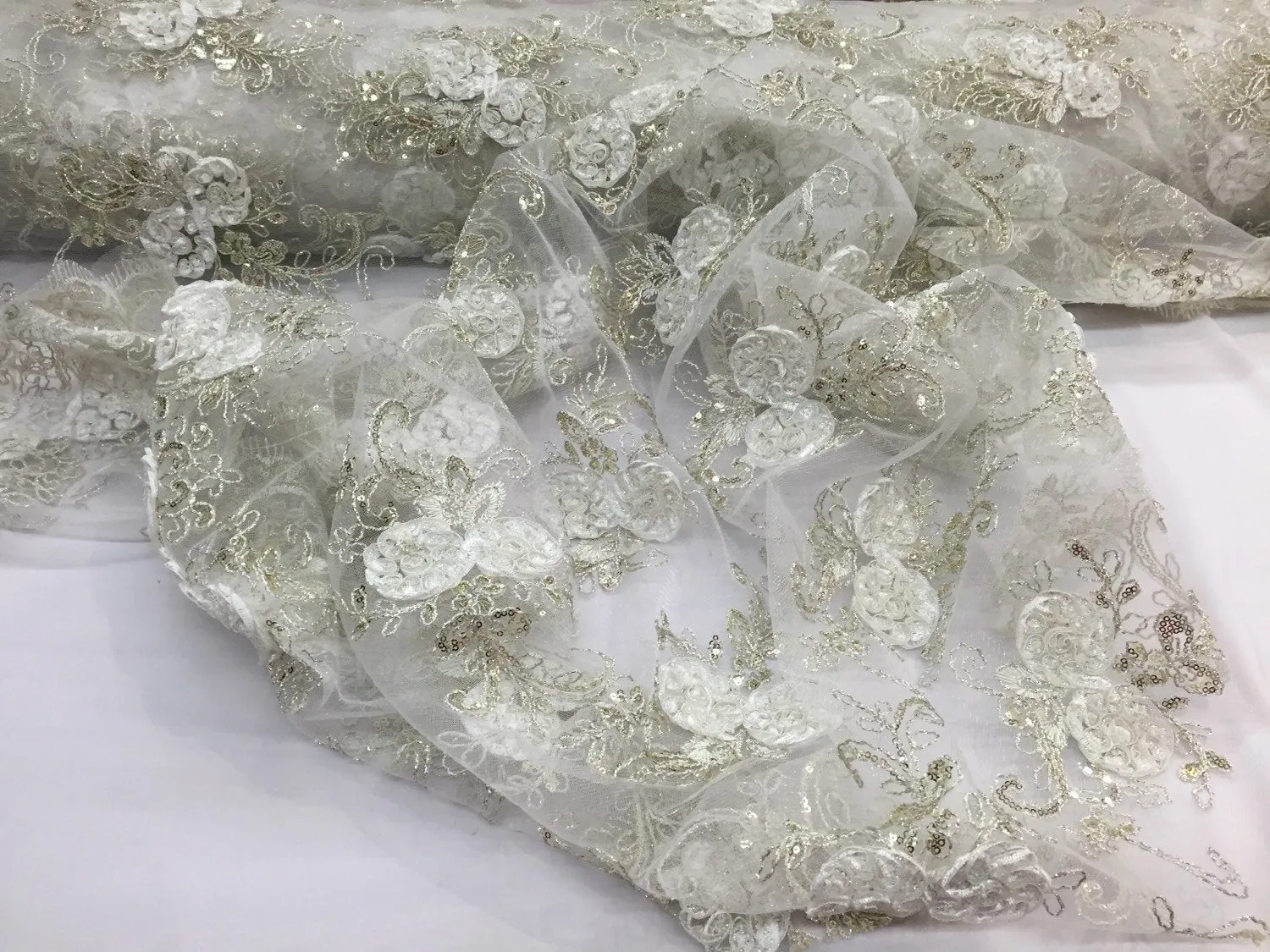 Ivory  3d flowers embroider with sequins on a mesh lace fabric. Sold by the yard.