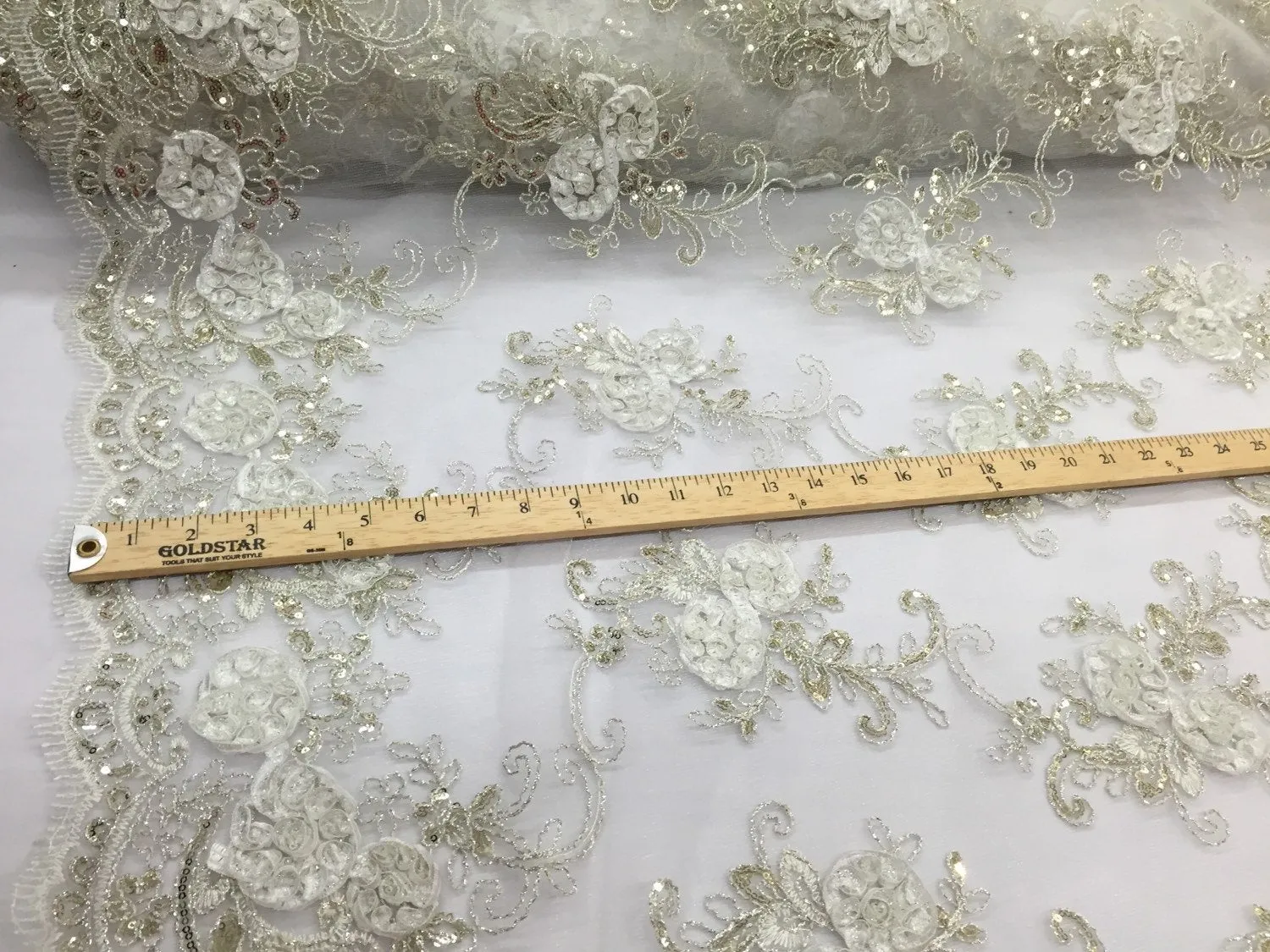 Ivory  3d flowers embroider with sequins on a mesh lace fabric. Sold by the yard.